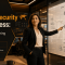 A female security professional confidently reviewing a security architecture diagram on a large screen, symbolizing strategic planning and readiness for CCNP Security.